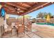 Inviting outdoor living area featuring comfortable seating, grill, and a pool with rock waterfall at 22412 N 20Th Pl, Phoenix, AZ 85024