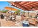 Outdoor patio with dining table, seating, grill, and view of lush landscaping and inviting pool at 22412 N 20Th Pl, Phoenix, AZ 85024