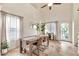 Light-filled dining space with tile flooring, modern table set, and views of front entrance at 22412 N 20Th Pl, Phoenix, AZ 85024