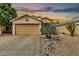 Charming home featuring a two-car garage and desert landscaping at 22412 N 20Th Pl, Phoenix, AZ 85024