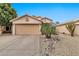 Charming single-story home with a two-car garage, low-maintenance landscaping, and a desert rock garden at 22412 N 20Th Pl, Phoenix, AZ 85024