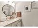 Elegant half-bathroom with a round mirror, modern sink and vanity, and stylish decor at 22412 N 20Th Pl, Phoenix, AZ 85024