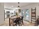 Bright kitchen featuring a wooden table with chairs and a door leading out to the pool area at 22412 N 20Th Pl, Phoenix, AZ 85024