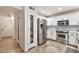 Modern kitchen with stainless steel appliances, white cabinets, pantry and tile floors at 22412 N 20Th Pl, Phoenix, AZ 85024