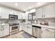 Beautiful kitchen with white cabinets, stainless steel appliances, and modern subway tile backsplash at 22412 N 20Th Pl, Phoenix, AZ 85024