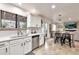 Bright kitchen with white cabinets, stainless steel appliances, and a view to the living area at 22412 N 20Th Pl, Phoenix, AZ 85024