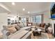 Comfortable living room featuring a large couch, tile floors, and natural light at 22412 N 20Th Pl, Phoenix, AZ 85024