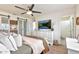 Bright main bedroom featuring a ceiling fan, dresser, and en suite bathroom at 22412 N 20Th Pl, Phoenix, AZ 85024