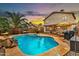 Backyard pool with rock feature, comfortable patio seating, BBQ grill, and ample entertaining space at 22412 N 20Th Pl, Phoenix, AZ 85024