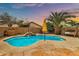 Backyard pool with waterfall feature, ample patio space, mature trees, and lounge swing at 22412 N 20Th Pl, Phoenix, AZ 85024