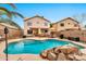 Backyard pool with patio, outdoor seating, built-in grill, and lush landscaping at 22412 N 20Th Pl, Phoenix, AZ 85024