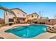 Resort-style pool with tanning ledge, rock features, outdoor kitchen, and lounge area at 22412 N 20Th Pl, Phoenix, AZ 85024