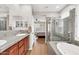 Bathroom with a glass shower, a bathtub, and double sinks at 2404 W Muirfield Dr, Anthem, AZ 85086