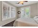 Bedroom features a ceiling fan, light walls, and shutters at 2404 W Muirfield Dr, Anthem, AZ 85086