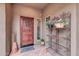 Charming front entrance featuring a wooden door and decorative flower display at 2404 W Muirfield Dr, Anthem, AZ 85086