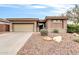 A single-story home with a two-car garage and desert landscaping at 2404 W Muirfield Dr, Anthem, AZ 85086