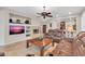 Open living room with a fireplace and a view into the kitchen at 2404 W Muirfield Dr, Anthem, AZ 85086