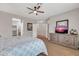 Cozy bedroom with a ceiling fan and a TV on the dresser at 2404 W Muirfield Dr, Anthem, AZ 85086