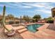 Backyard features a pool, spa, desert landscaping, and a privacy fence at 2404 W Muirfield Dr, Anthem, AZ 85086