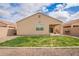 Inviting backyard featuring a well-maintained lawn, covered patio, and ample space for outdoor enjoyment at 28916 N Selenite Ln, San Tan Valley, AZ 85143