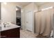 Bright bathroom featuring double sink vanity, tile flooring, and separate closet at 28916 N Selenite Ln, San Tan Valley, AZ 85143