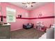 Charming pink bedroom with a large window, comfortable bed, and carpet floors at 28916 N Selenite Ln, San Tan Valley, AZ 85143