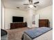 Spacious bedroom with carpet flooring and a large television set for entertainment at 28916 N Selenite Ln, San Tan Valley, AZ 85143