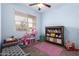 Playful bedroom with a dollhouse, rocking horse and built-in shelves at 28916 N Selenite Ln, San Tan Valley, AZ 85143