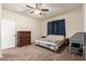 Comfortable bedroom featuring carpeted floors, ceiling fan, and plenty of natural light at 28916 N Selenite Ln, San Tan Valley, AZ 85143