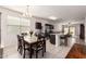 Bright dining area with a stone table, dark wood chairs, and an open flow to the kitchen and living spaces at 28916 N Selenite Ln, San Tan Valley, AZ 85143