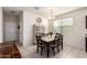 Bright dining area with a modern chandelier, a china cabinet and a stone-topped table with seating for six at 28916 N Selenite Ln, San Tan Valley, AZ 85143