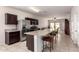 Open-concept kitchen with stainless steel appliances, a large granite island, and bar stool seating at 28916 N Selenite Ln, San Tan Valley, AZ 85143