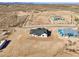 Desert home featuring a modern exterior, dark gray roof surrounded by desert landscape and mountains at 35597 W Jones Ave, Tonopah, AZ 85354