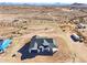 New construction home featuring a modern design, a spacious lot, and a large garage in a desert landscape at 35597 W Jones Ave, Tonopah, AZ 85354