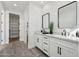 Bathroom featuring dual sinks, white cabinets, and modern fixtures at 35597 W Jones Ave, Tonopah, AZ 85354