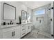 Bathroom with dual vanity, framed mirror, and glass-enclosed shower at 35597 W Jones Ave, Tonopah, AZ 85354