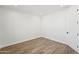 Neutral bedroom featuring modern wood-look tile floors, and bright white walls and trim at 35597 W Jones Ave, Tonopah, AZ 85354