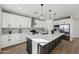 Modern kitchen featuring a large central island, stainless steel appliances, and elegant pendant lighting at 35597 W Jones Ave, Tonopah, AZ 85354