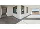 Covered patio features neutral color scheme, large windows, and a concrete floor at 35597 W Jones Ave, Tonopah, AZ 85354