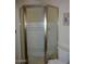 Corner shower with gold trim and patterned glass doors at 409 S Mountain View Dr, Kearny, AZ 85137