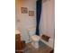 Bathroom featuring blue shower curtains, a toilet, and beige walls at 409 S Mountain View Dr, Kearny, AZ 85137