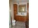 Bathroom featuring wood cabinets, single sink, and a white countertop at 409 S Mountain View Dr, Kearny, AZ 85137