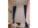 Cozy bathroom with blue shower curtains, a toilet, and neutral walls at 409 S Mountain View Dr, Kearny, AZ 85137