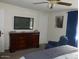 Comfortable bedroom with a large dresser, TV, and a cozy blue armchair at 409 S Mountain View Dr, Kearny, AZ 85137