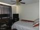 Neutral bedroom with a ceiling fan, desk area, and patterned bedding at 409 S Mountain View Dr, Kearny, AZ 85137