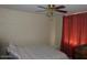 Bedroom featuring a ceiling fan, brick wall, and patterned bedding at 409 S Mountain View Dr, Kearny, AZ 85137