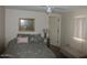 Bedroom featuring floral bedding, a side table, and window with blinds at 409 S Mountain View Dr, Kearny, AZ 85137