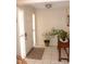 Bright entryway featuring a white front door, tile flooring, and wooden console table at 409 S Mountain View Dr, Kearny, AZ 85137