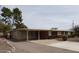 This home has a large parking area with an attached carport and neat shrubbery at 409 S Mountain View Dr, Kearny, AZ 85137