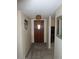 Hallway featuring carpet and a wooden front door with decorative hardware and lighting at 409 S Mountain View Dr, Kearny, AZ 85137